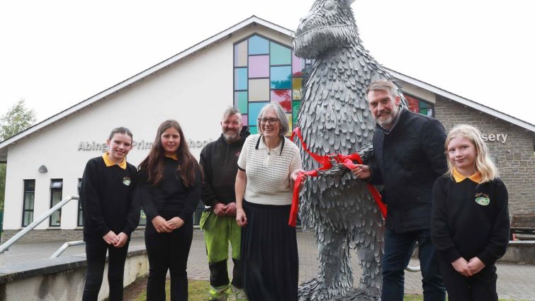Head Teacher Kay Macpherson, council rep, Kenny Lean, sculptor Kev Paxton and three pupils cut the ribbon to unveil the new Gruffalo sculpture in front of Abington primary school.
