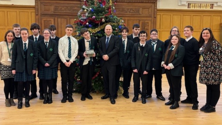 Councillor Mark McGeever presents a camera to ASN pupils at Hamilton Grammar School whose biodiversity film won a council competition.