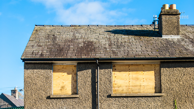 This is a generic image of a home boarded up 