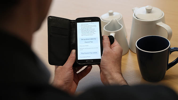 This is a picture of a smartphone with the South Lanarkshire Council website opened to show the Council Tax payments page