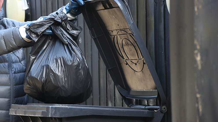 Waste being emptied into a bin