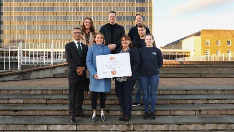 This image shows the team who are working on moving community alarm systems from analogue to digital outside council HQ with their Bronze award