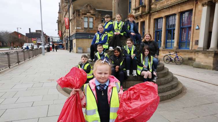 Burgh primary school pupils and teacher litter picking outside Rutherglen Town Hall