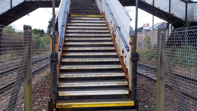 This image shows a set of stairs at Burnside railway station leading from the platform to a bridge