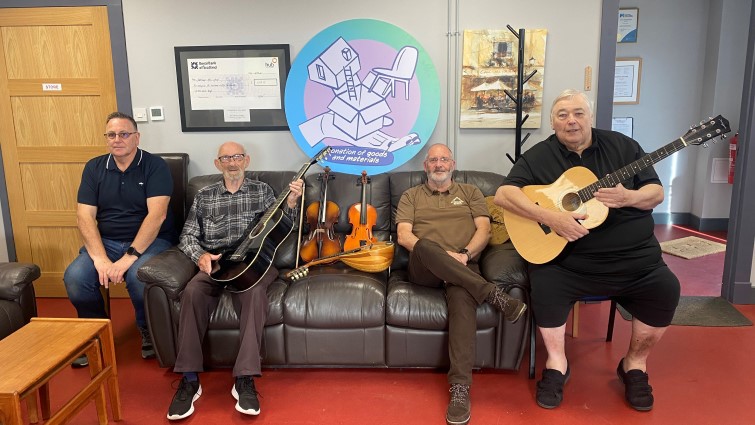 This image shows members of Stonehouse Men's Shed with instruments donated to them thanks to the Council's Community Wish List