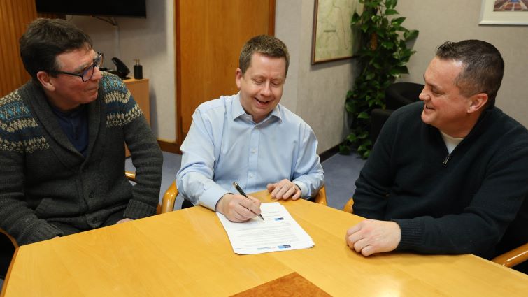 This image shows chief executive Paul Manning with two representatives from the voluntary sector signing The South Lanarkshire Third Sector Partnership Agreement