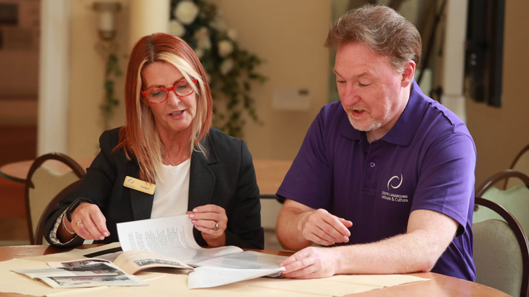 This image shows SLLC employees Christine Slowey and Peter Kerr looking at files which assisted in the publication of the Tales of The Palace and Low Parks booklet