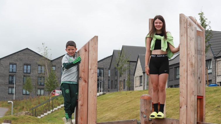 This image shows a boy and girl playing at the Whitlawburn housing development in Cambuslang