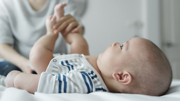 This is a getty image of a baby having its nappy changed