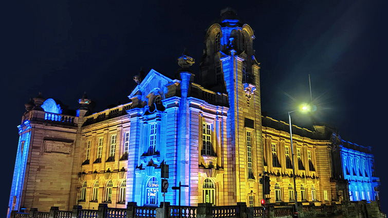 This images shows Hamilton Town House lit up in the colours of the flag of Ukraine as the full Council has condemned Russia in a unified message of support for the people of Ukraine