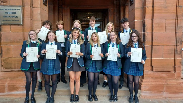 This image shows pupils from Hamilton Grammar outside the school with their exam results