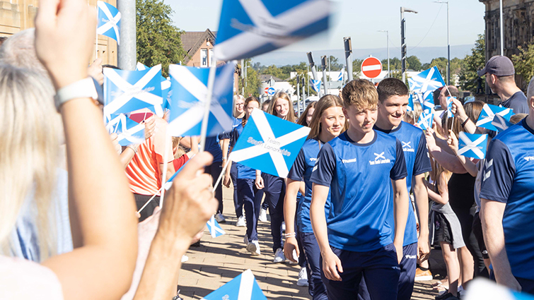 This image shows Team SL being cheered by parents and supporters as they head to Coventry for the international Children's Games