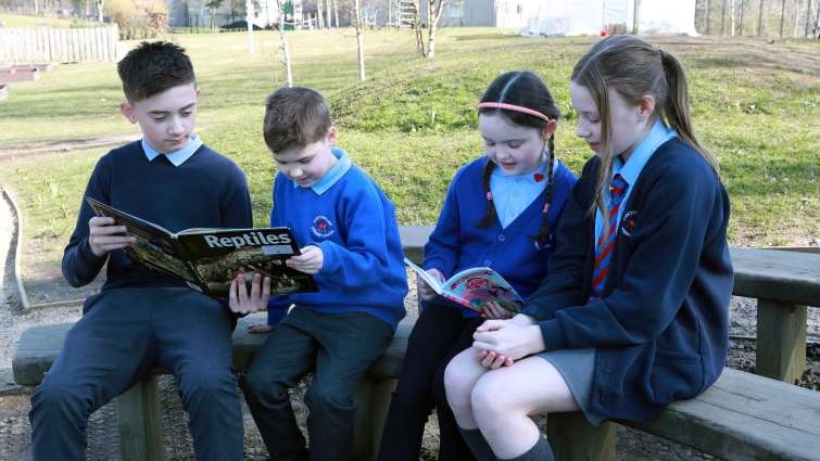 pupils reading in an outside environment