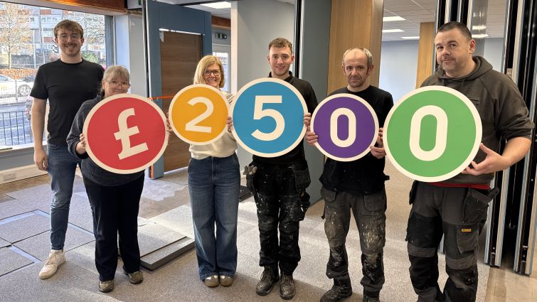 This image shows members of LEAP holding up numbers reading &pound;2500 which is the amount they got from Participatory Budgeting funding to help create a new community hub