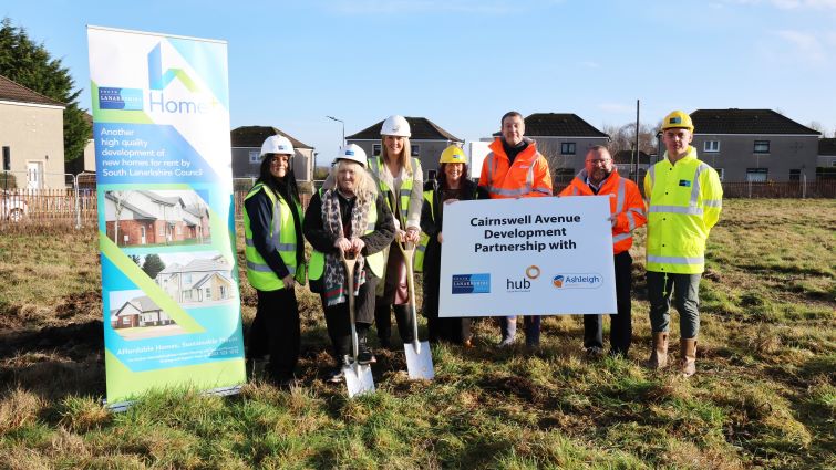This image shows a group of people including Councillor Margaret Cowie at a sod cutting event to mark the start of new homes being build in Cambuslang