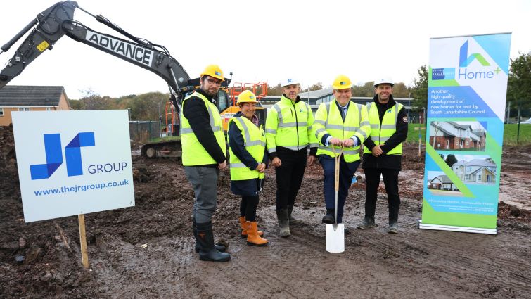 This image shows Councillor Davie McLachlan with reps from the council and the JR Group at a sod cutting ceremony to mark the start of work on 24 new homes in Whitehill, Hamilton