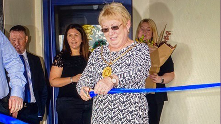 Provost Margaret Cooper cuts a ribbon to officially re-open Strathaven Rugby Club's carbon-neutral facilities.