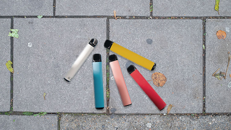 This image shows a collection of vapes on the ground