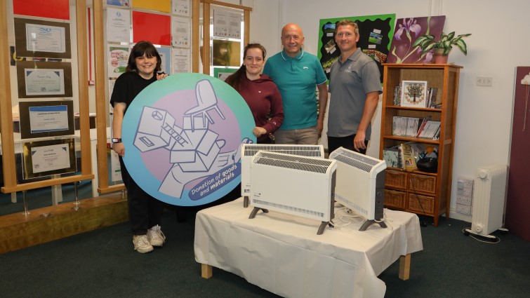 This image shows Agape members of staff with a Findel representative following their donation of three convector heaters through the council's community wish list
