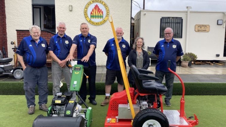 This image shows members of Coalburn Bowling Club with new greenkeeping equiment