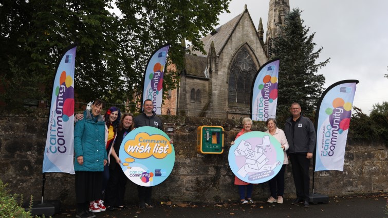 This image shows members of Blantyre Old Parish Church and the architects who fitted a light to let a defibrillator outside the church be seen easily in the dark