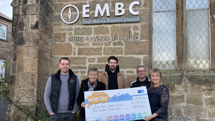 This shows representatives from East Mains Baptist Church after they were supported with a £500 donation through the council's Community Wish List by Ailsa Building Construction