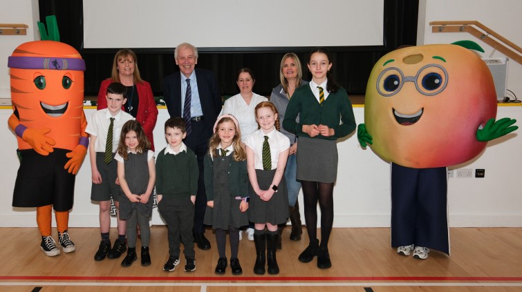 Councillor Robert Brown with pupils and kitchen staff at St Patrick's Primary School and Nursery celebrating having the highest uptake in their area for this year's World Book Day challenge