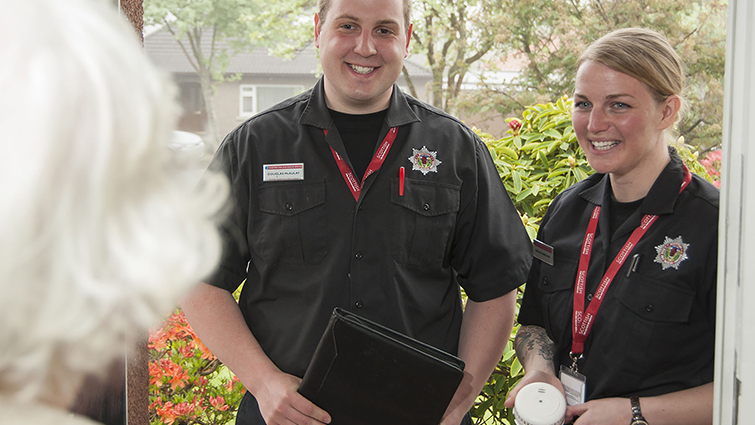 This image shows two fire officers on a safety visit