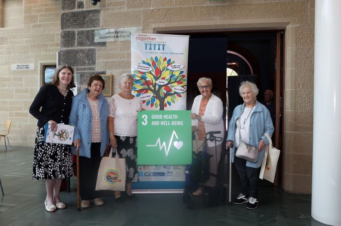 This photo shows a group of older people gathered in the atrium area of Rutherglen Town Hall at the recent event.