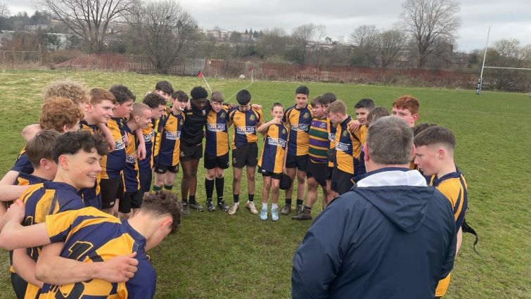 This is a general image of one of Strathaven Rugby Club's youth teams getting a team talk on the pitch by their coach