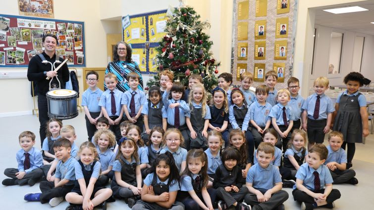 Professional drummer and FP Grant Cassidy with P1 pupils and teacher Noleen Summers at St John the Baptist PS, Uddingston.