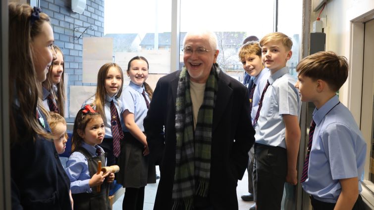 Hollywood composer and former pupil Patrick Doyle is greeted by pupils at St John the Baptist PS, Uddingston.